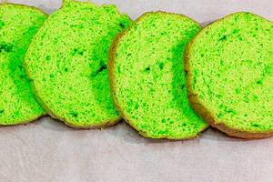 Green sliced sponge biscuit on parchment paper