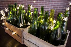 Green wine bottles sorrounded with tiny lights