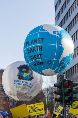 Greenpeace organisation raises big balloons with Planet Earth first message on it