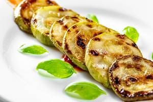 Grilled courgettes with fresh Basil leaves