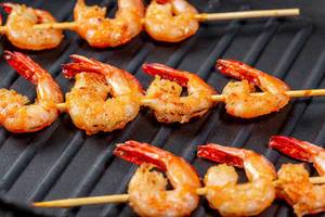Grilled shrimp tails on black background