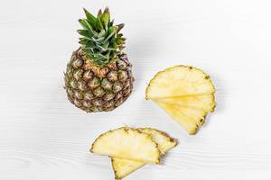 Half and pieces of fresh pineapple on white background (Flip 2019)