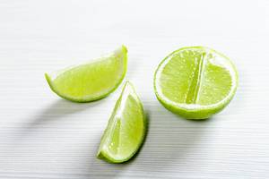 Half and pieces of ripe lime on white background (Flip 2019)