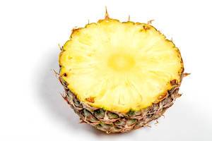 Half ripe fresh pineapple on white background