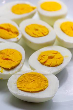 Halves of boiled eggs on a white plate