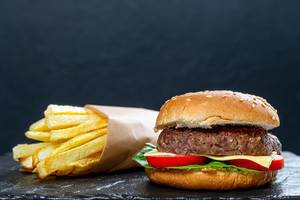 Hamburger and fries on black background (Flip 2019)