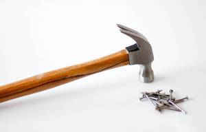 Hammer with Nails on a White Background