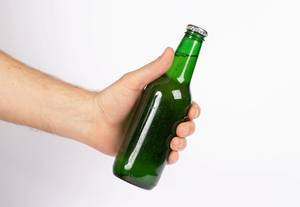 Hand holding beer bottle without label isolated on white background