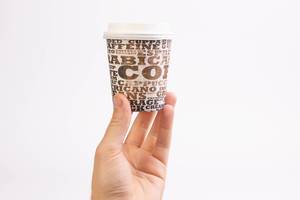 Hand holding coffee cup on white background