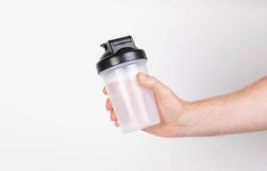 Hand holding empty protein shaker