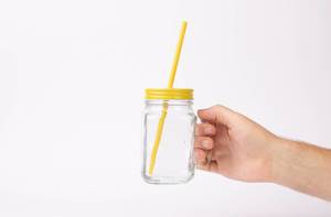 Hand holding glass with drinking straw (Flip 2019)