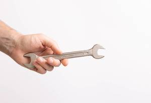 Hand holding handle wrench