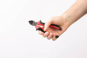 Hand holding Pliers isolated on white background (Flip 2019)