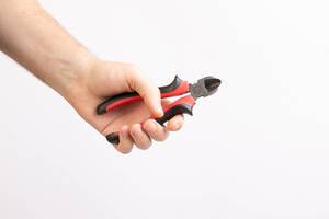 Hand holding Pliers isolated on white background