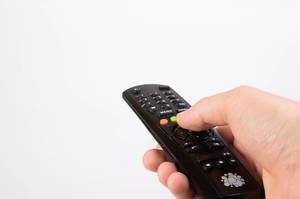 Hand holding tv remote control