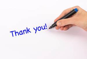 Hand mit Edding-Marker schreibt "Thank you!" - Dankeschön