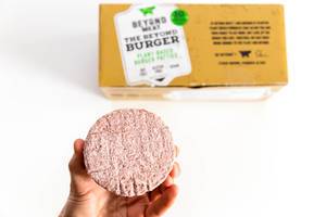 Hand shows Beyond Meat Patty, the vegan alternative of burger meat for a more sustainable world