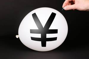 Hand uses a needle to burst a balloon with Japanese Yen symbol