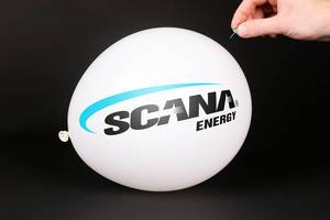 Hand uses a needle to burst a balloon with Scana Energy logo