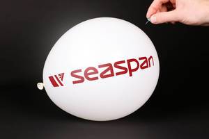 Hand uses a needle to burst a balloon with Seaspan logo