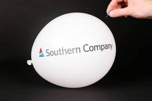 Hand uses a needle to burst a balloon with Southern Company logo
