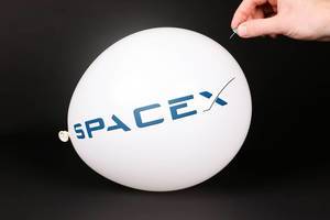 Hand uses a needle to burst a balloon with SpaceX logo
