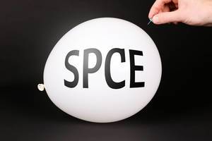 Hand uses a needle to burst a balloon with SPCE text