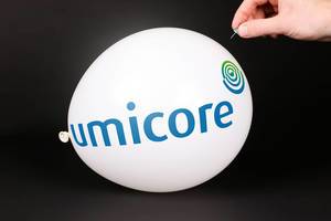 Hand uses a needle to burst a balloon with Umicore logo