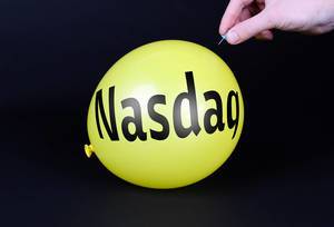 Hand uses a needle to burst a yellow balloon with Nasdaq text
