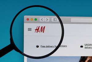 H&M logo under magnifying glass