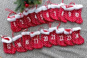 Handmade Advent calendar made of red and white socks with numbers on them