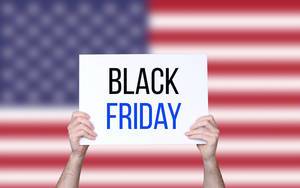 Hands holding board with Black Friday text with USA flag background.jpg