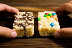 Hands holding two rice krispies blocks