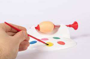 Hands painting eggs for Easter holiday