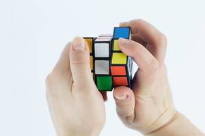 Hands playing a cube game