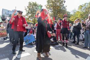 Happily disguised demonstrators dance and sing for our climate