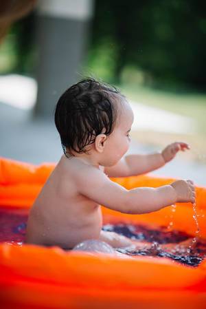 Happy baby having fun in a pool  Flip 2019
