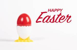 Happy Easter text with red painted Easter egg