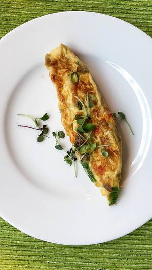 Hausgemachte Omelette mit Ei, Zucchini, Spinat und Basilikum