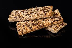 Healthy Bars with Sesame Sunflowers Seed and other cereals above black background (Flip 2019)