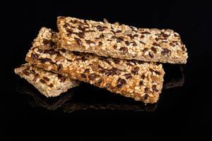 Healthy Bars with Sesame Sunflowers Seed and other cereals above black background