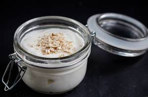 Healthy breakfast to go - natural yogurt with cereals in a glass jar
