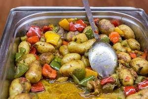 Healthy, new potatoes with colourful sweet pepper curry in a heat container at the lunch buffet in the AXA building in Cologne, during Barcamp OMWest19