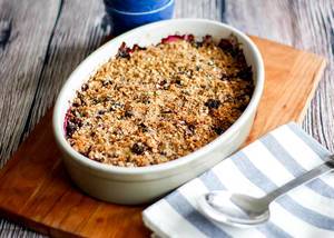 Homemade berries crumble pie in oval backing pan