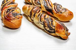 Homemade buns-pigtails with poppy seeds