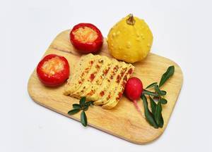 Homemade cheese with peppers and herbs