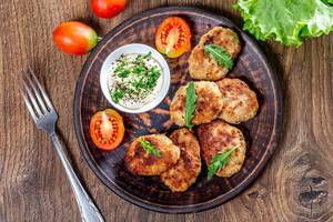 Homemade fried meat cutlets with sauce and herbs (Flip 2019)