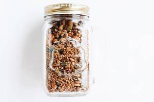 Homemade granola in a jar. Healthy food on white background