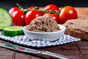 Homemade liver pate with vegetables and black bread