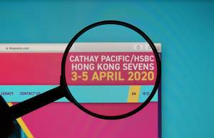 Hong Kong Sevens text on a computer screen with a magnifying glass